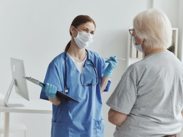 nurse consulting with elderly patient