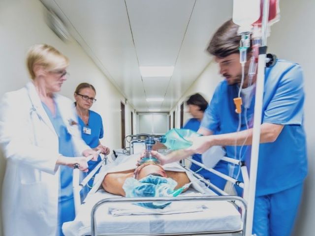 nursing team rushing patient to OR
