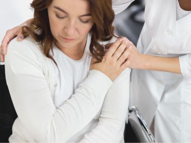 nurse comforting patient during discharge