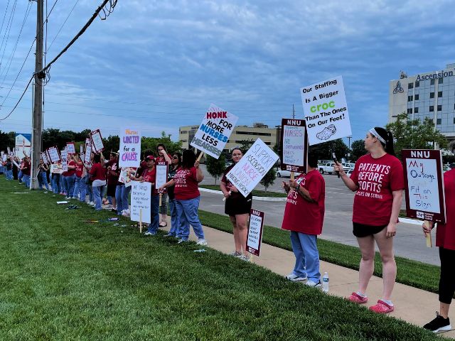 Picket line of nurses holding signs outside of Ascension Hospital in Wichita, KS.