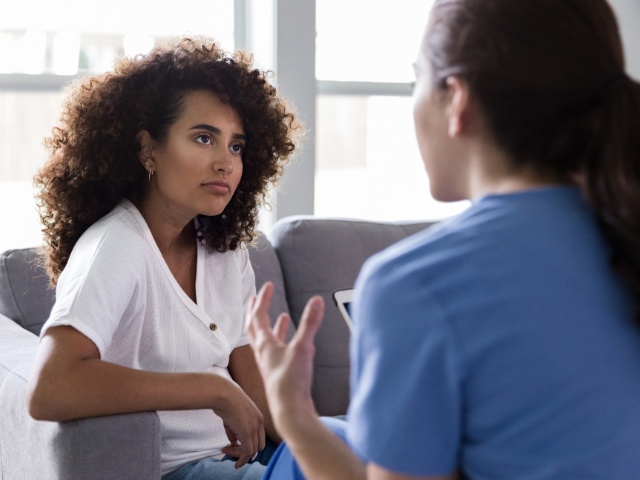 A nurse speaks to a patient