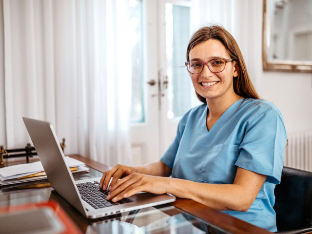 Nurse renewing LPN license on her home computer