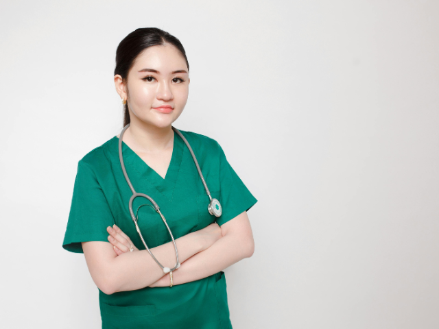 A young nurse struggling with early-tenure nurse turnover poses for a photo.