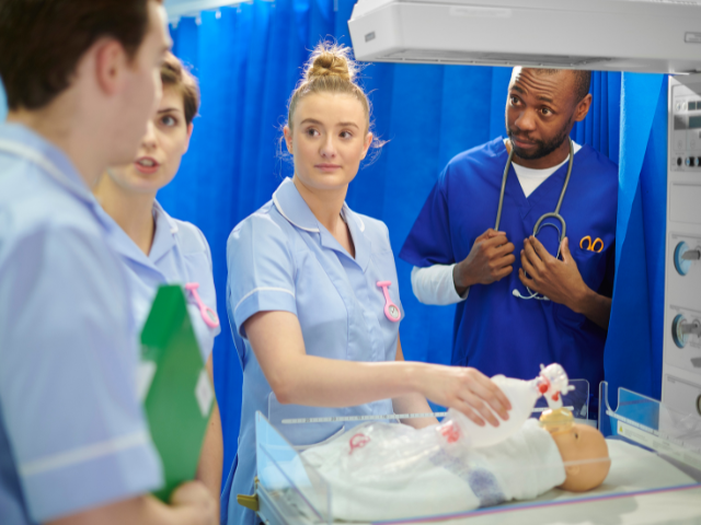 Nurses learn pediatric care on a baby mannequin
