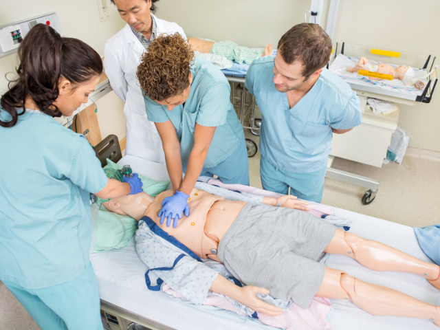 Nurses learn proper care techniques on a mannequin