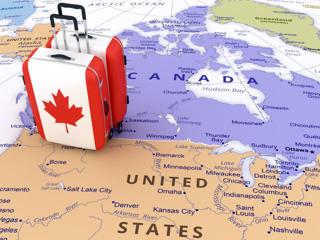 A map depicting Canadian flag themed suitcases sitting at the U.S.-Canada border.