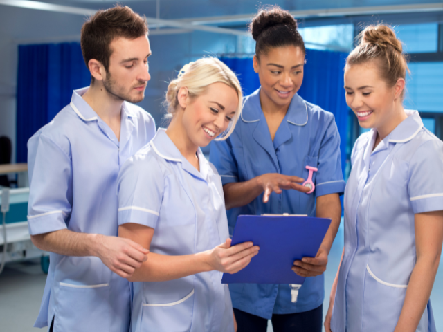 A group of nursing students listen to a nurse educator.